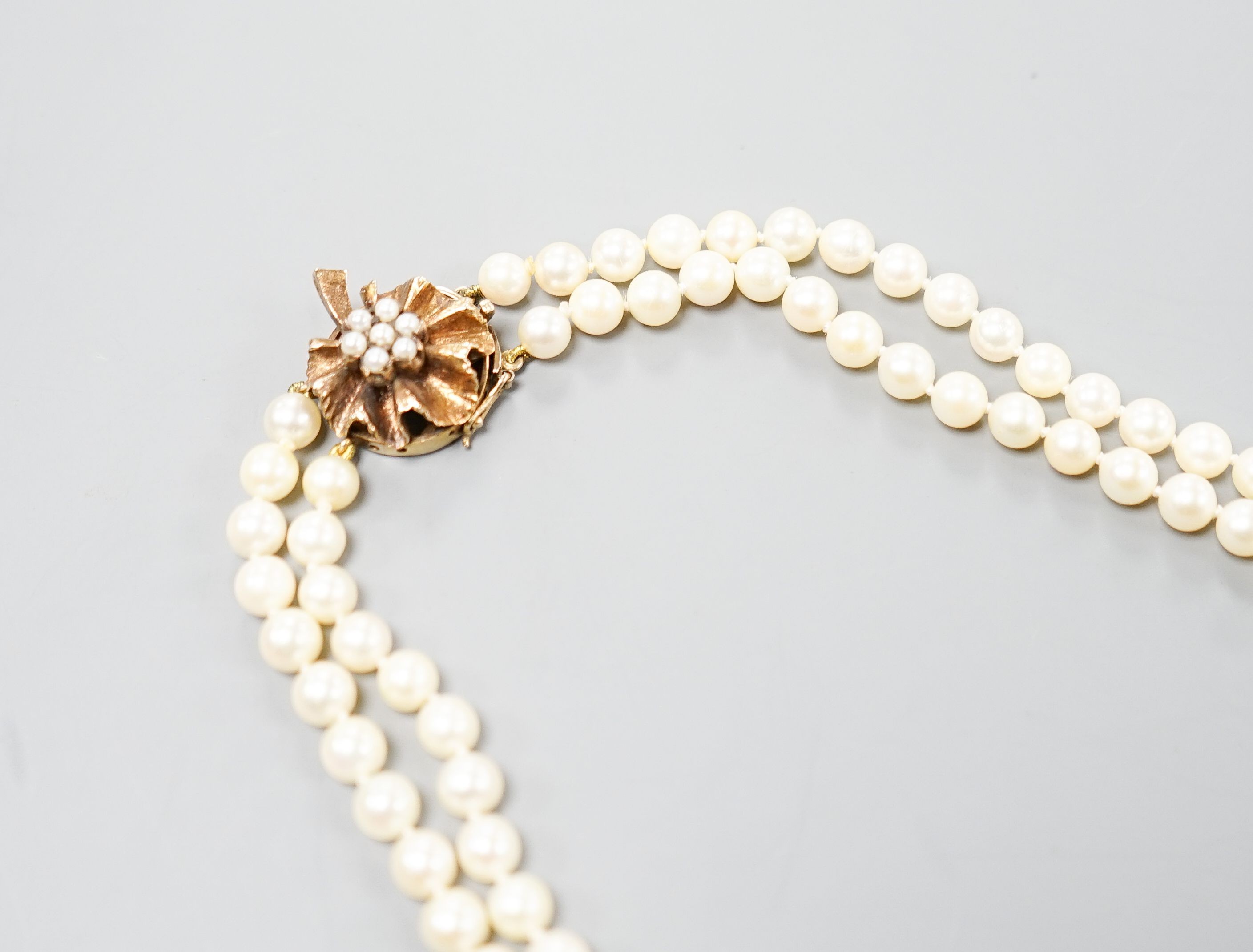 A double strand cultured pearl choker necklace, with cultured pearl set 9ct gold clasp, 38cm, with spare loose pearls.